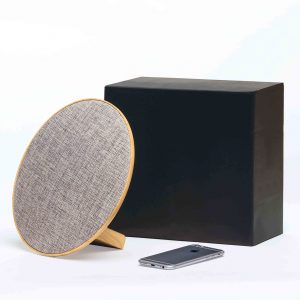 The Catalogue Lounge Disc Bluetooth Speaker is a wireless speaker with a fabric face. USB charging cable included.