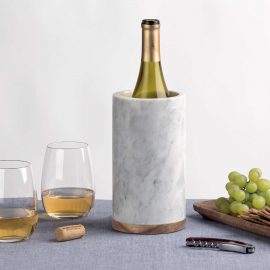 The Catalogue Vino Marble Cooler is a marble cooler with an acacia wood base. White marble. Insulating to keep bottles chilled.